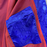 Flat lay presentation of Gucci luxury clothing with label-forward styling