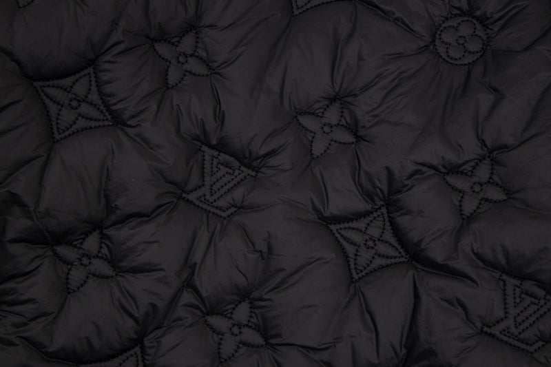 Flat lay presentation of Louis Vuitton luxury clothing with monogram-inspired silhouette