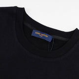 Flat lay presentation of Louis Vuitton luxury clothing with label-forward styling