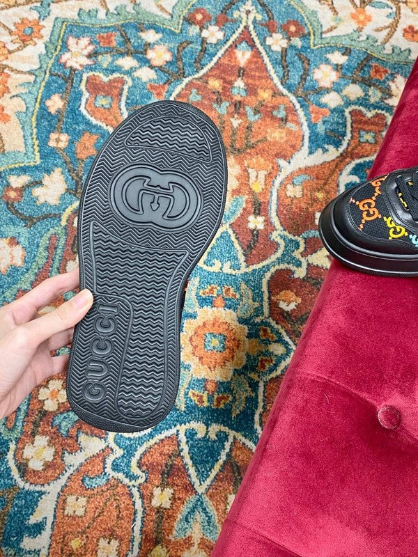 Side profile of Gucci all-black sneakers low-top design