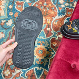 Side profile of Gucci all-black sneakers low-top design