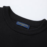 Close-up detail shot of Louis Vuitton luxury clothing with label-forward styling