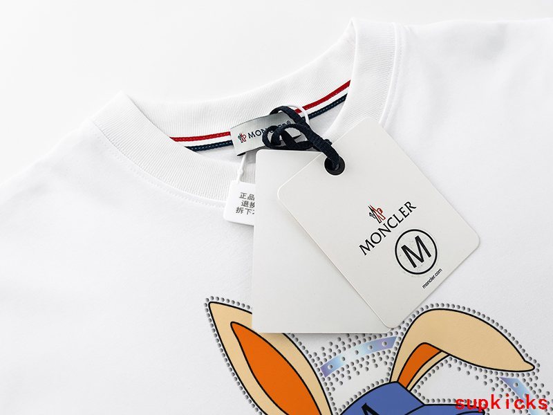 Flat lay presentation of Moncler luxury clothing with everyday silhouette