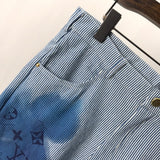 Close-up detail shot of Louis Vuitton luxury clothing with logo-detail design