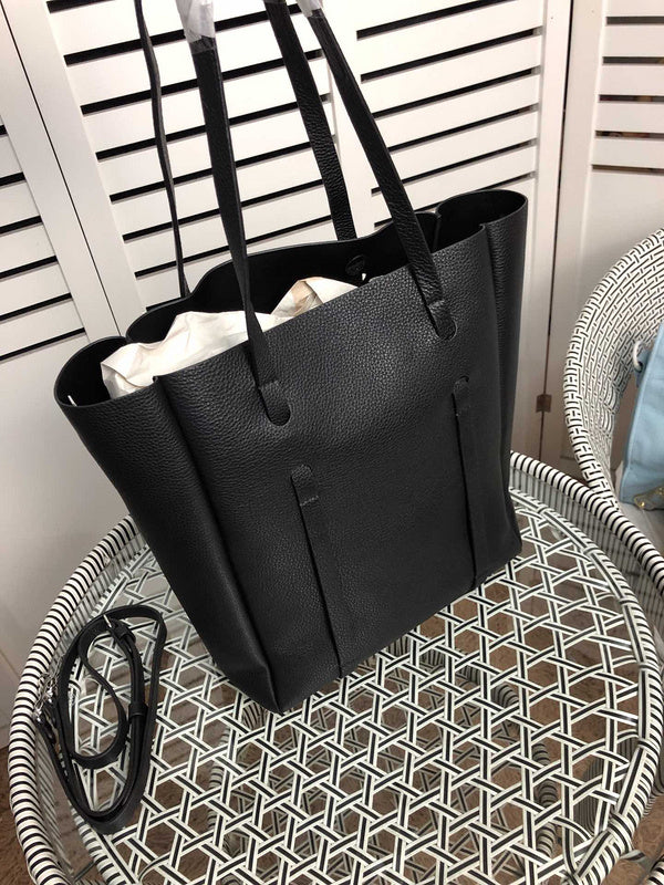 Handle and strap detail of polished chic women's handbag – women's designer-style accessory