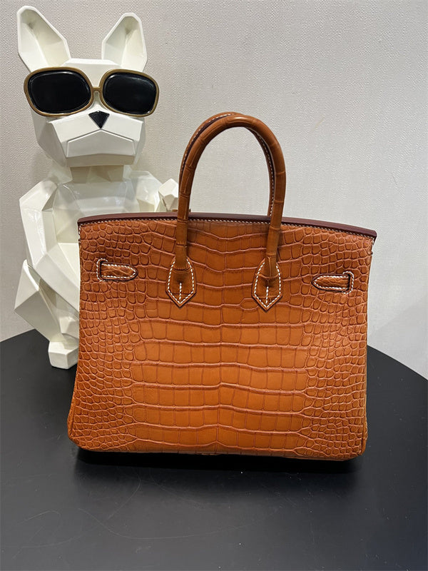  Timeless top-handle bag carried on shoulder
