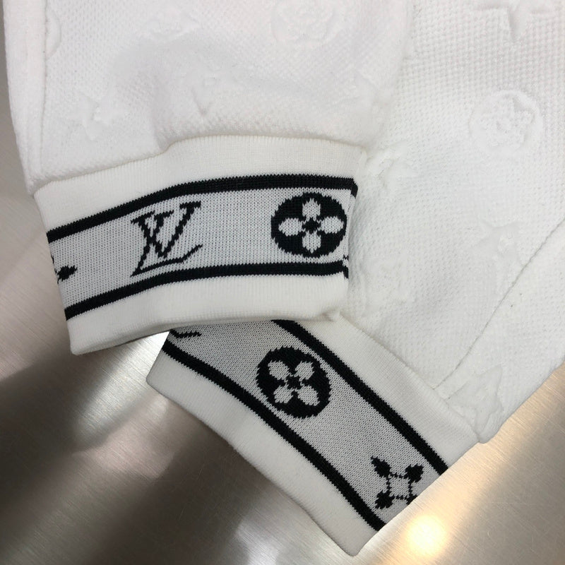 Flat lay presentation of Louis Vuitton luxury clothing with monogram-inspired silhouette