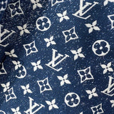 Flat lay presentation of Louis Vuitton luxury clothing with label-forward styling