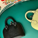  Refined top-handle bag carried on shoulder