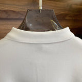 Front view of Louis Vuitton luxury clothing with label-forward styling