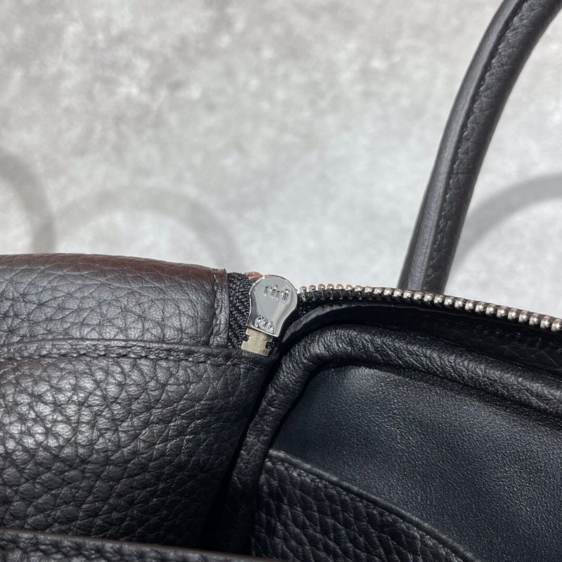 Side view of polished structured handbag