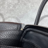 Side view of polished structured handbag