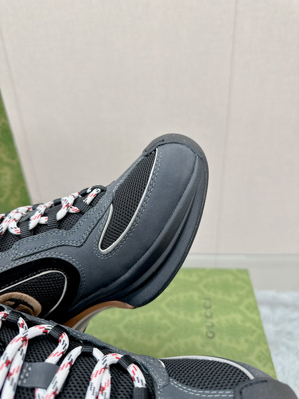 Side profile of Gucci all-black sneakers low-top design