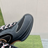 Side profile of Gucci all-black sneakers low-top design