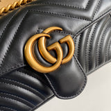 Back view of classic polished women's handbag – women's statement bag