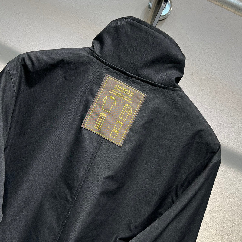 Flat lay presentation of Louis Vuitton luxury clothing with label-forward styling