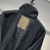 Flat lay presentation of Louis Vuitton luxury clothing with label-forward styling