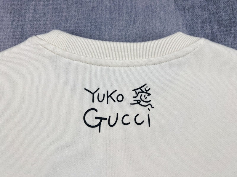 Front view of Gucci luxury clothing with signature branding