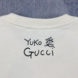 Front view of Gucci luxury clothing with signature branding