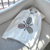 Flat lay presentation of Gucci luxury clothing with monogram-inspired silhouette