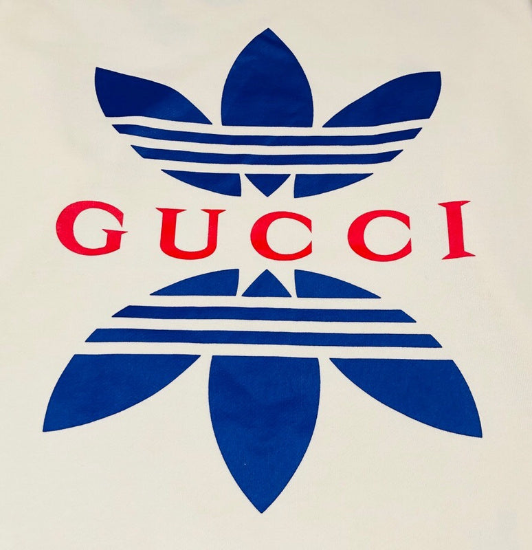 Flat lay presentation of Gucci luxury clothing with monogram-inspired silhouette