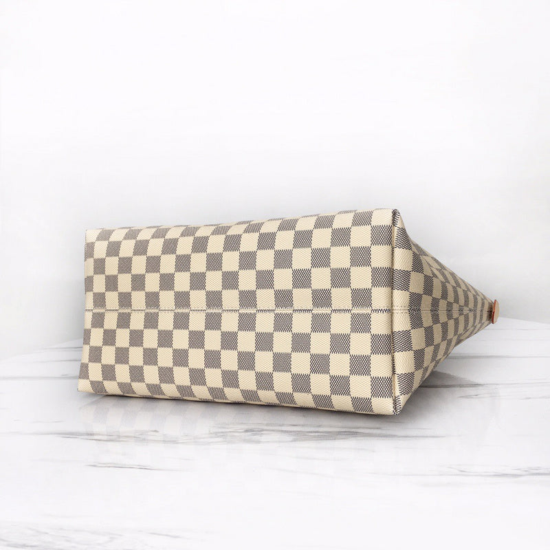 Styled lifestyle shot of signature polished women's handbag – women's everyday handbag