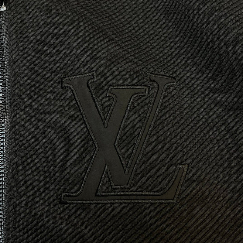 Flat lay presentation of Louis Vuitton luxury clothing with label-forward styling