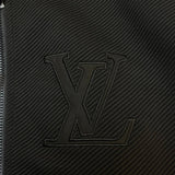 Flat lay presentation of Louis Vuitton luxury clothing with label-forward styling