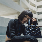  Sleek structured bag carried on shoulder 34