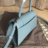 Handle and strap detail of polished classic women's handbag – women's luxury accessory