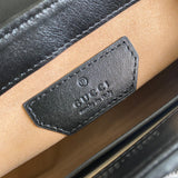 Side profile of refined signature women's handbag – women's luxury accessory