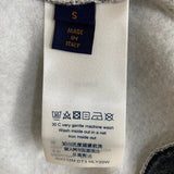Side profile of Louis Vuitton luxury clothing with label-forward styling