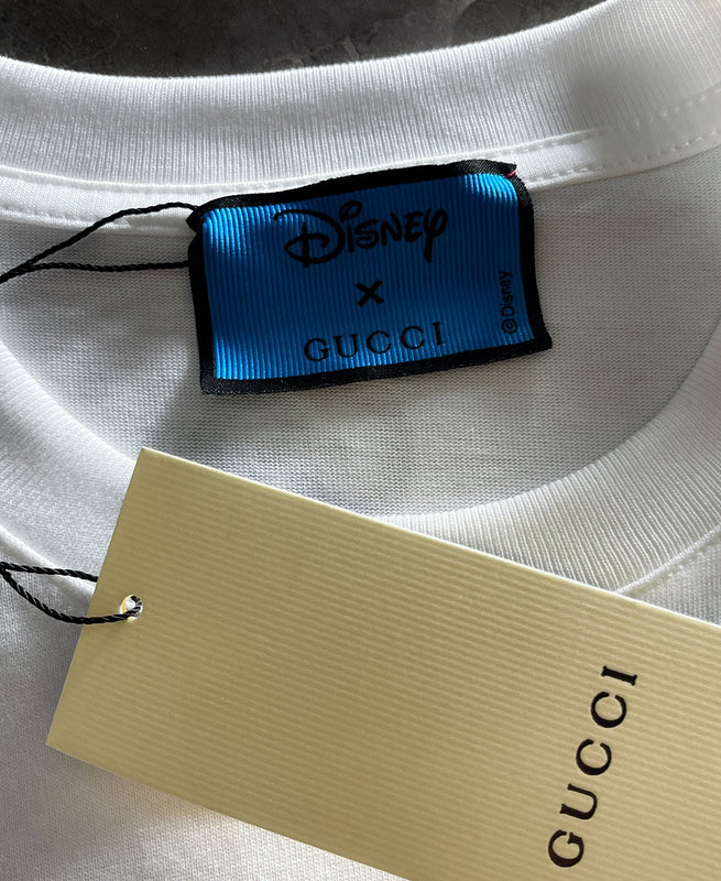 Flat lay presentation of Gucci luxury clothing with monogram-inspired silhouette