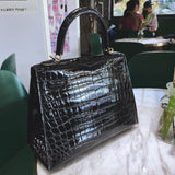 Side view of sculpted structured handbag
