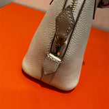  Minimalist top-handle bag carried on shoulder