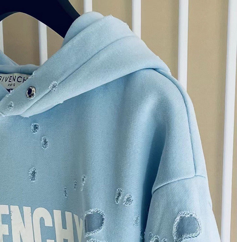 Close-up detail shot of Givenchy luxury clothing with logo-detail design