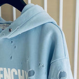 Close-up detail shot of Givenchy luxury clothing with logo-detail design
