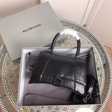 Front view of polished chic women's handbag – women's statement bag