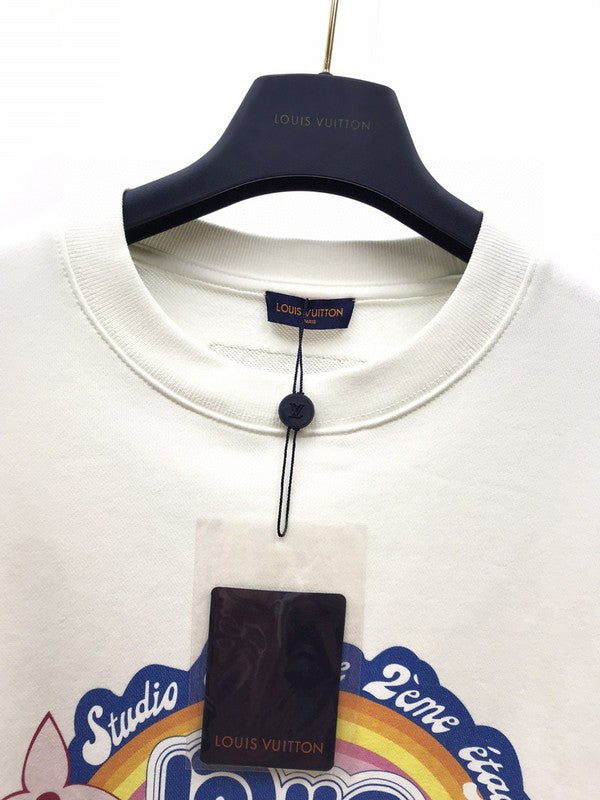 Flat lay presentation of Louis Vuitton luxury clothing with label-forward styling