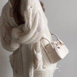 Side view of sculpted structured handbag