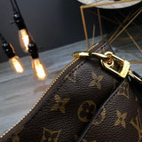 Handle and strap detail of classic sleek women's handbag – women's statement bag