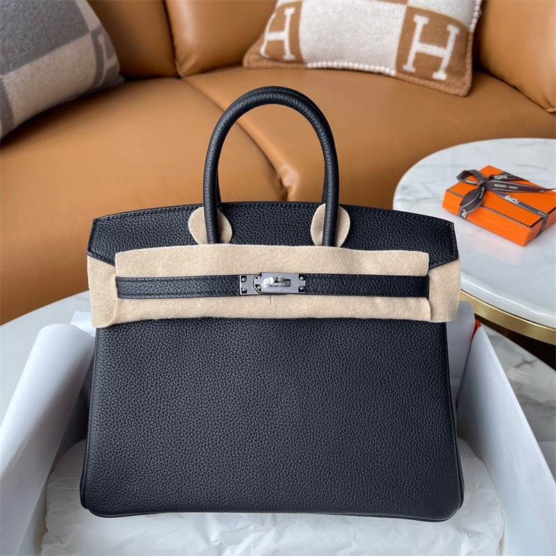  Classic top-handle bag carried on shoulder