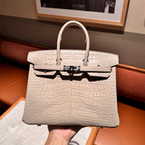 Side view of sculpted structured handbag