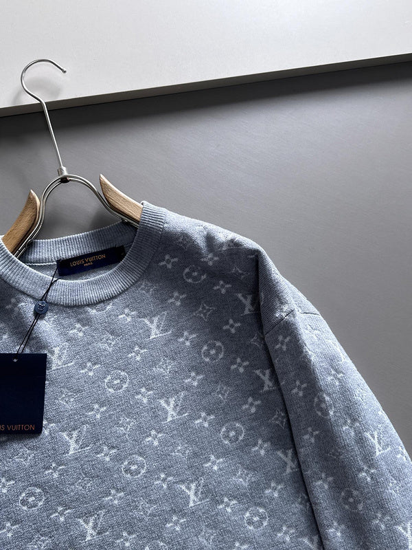 Flat lay presentation of Louis Vuitton luxury clothing with label-forward styling