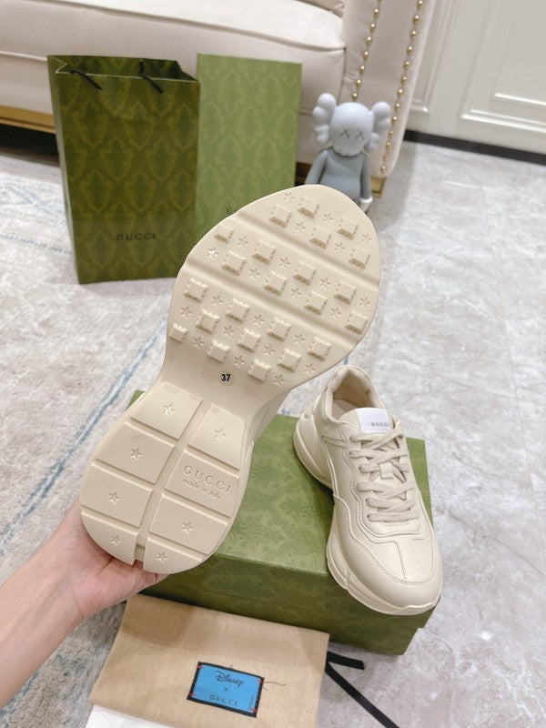 Side profile of Gucci classic monochrome sneakers retro runner design