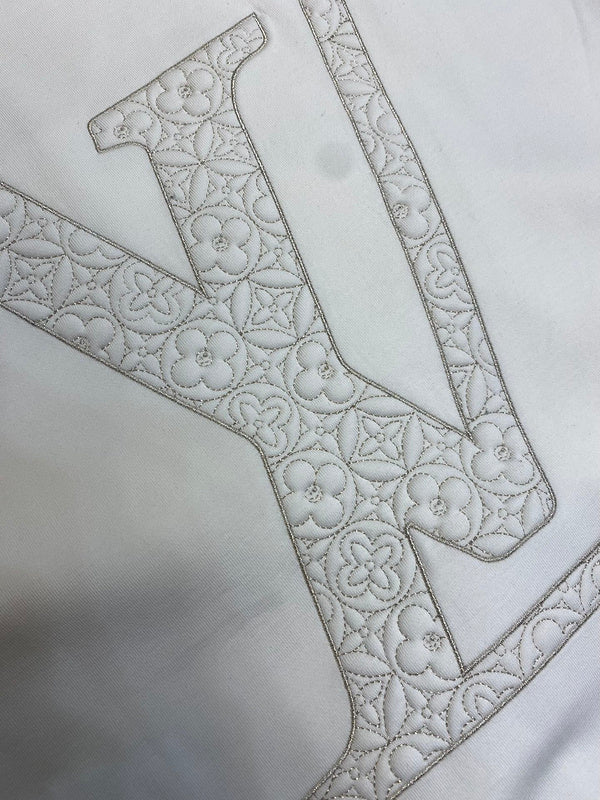Close-up detail shot of Louis Vuitton luxury clothing with runway-inspired design