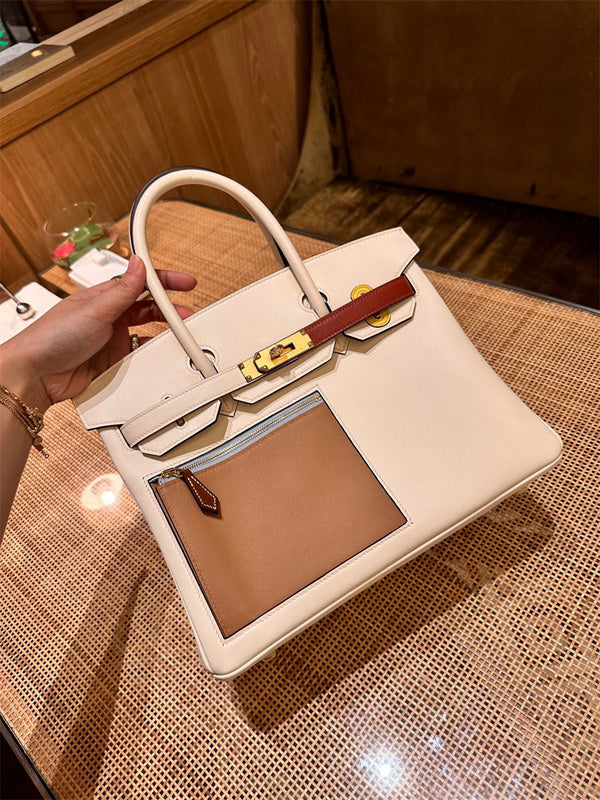  Signature tote bag carried on shoulder