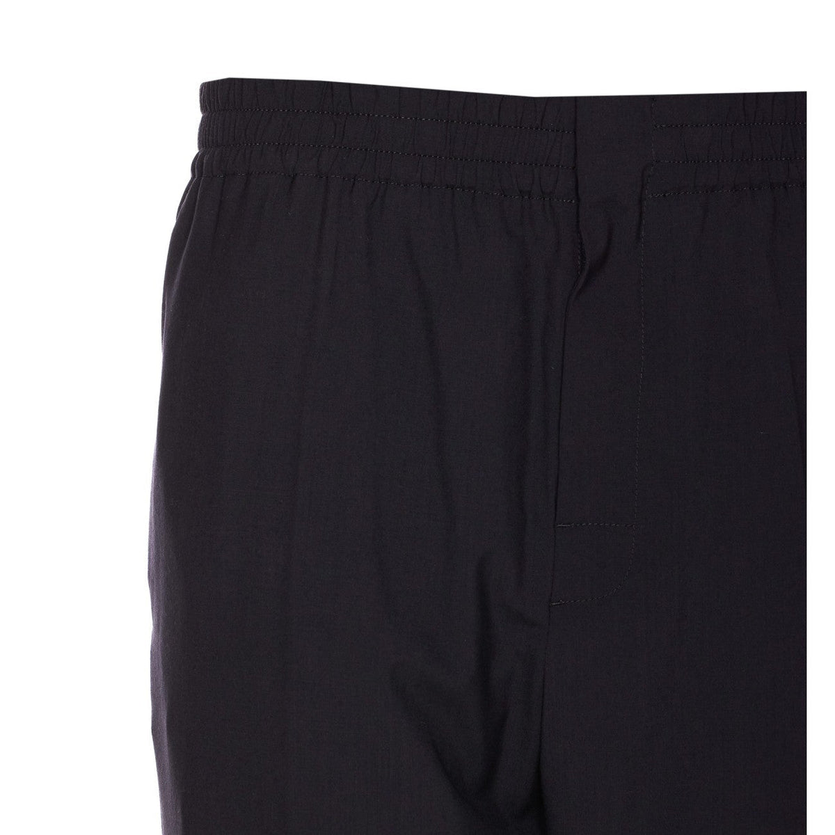 Close-up of Bottega Veneta pants hardware and fine stitching