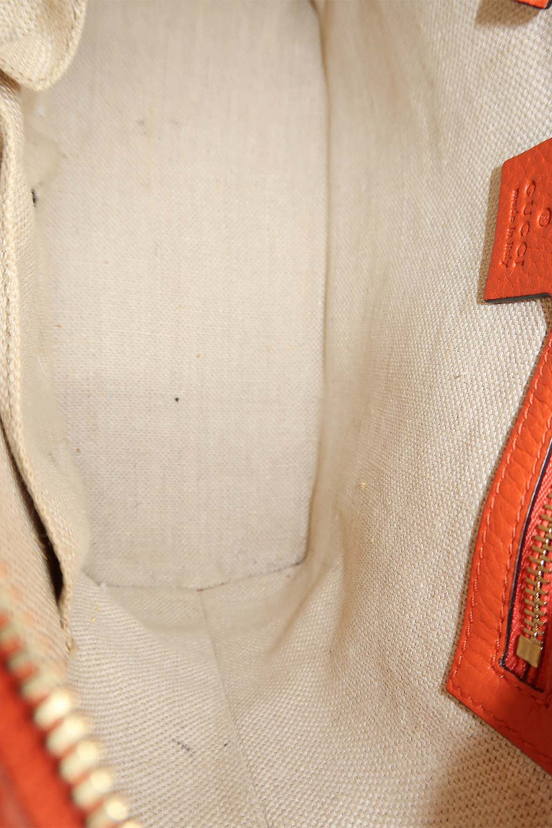 Close-up of Belted bags hardware and fine stitching