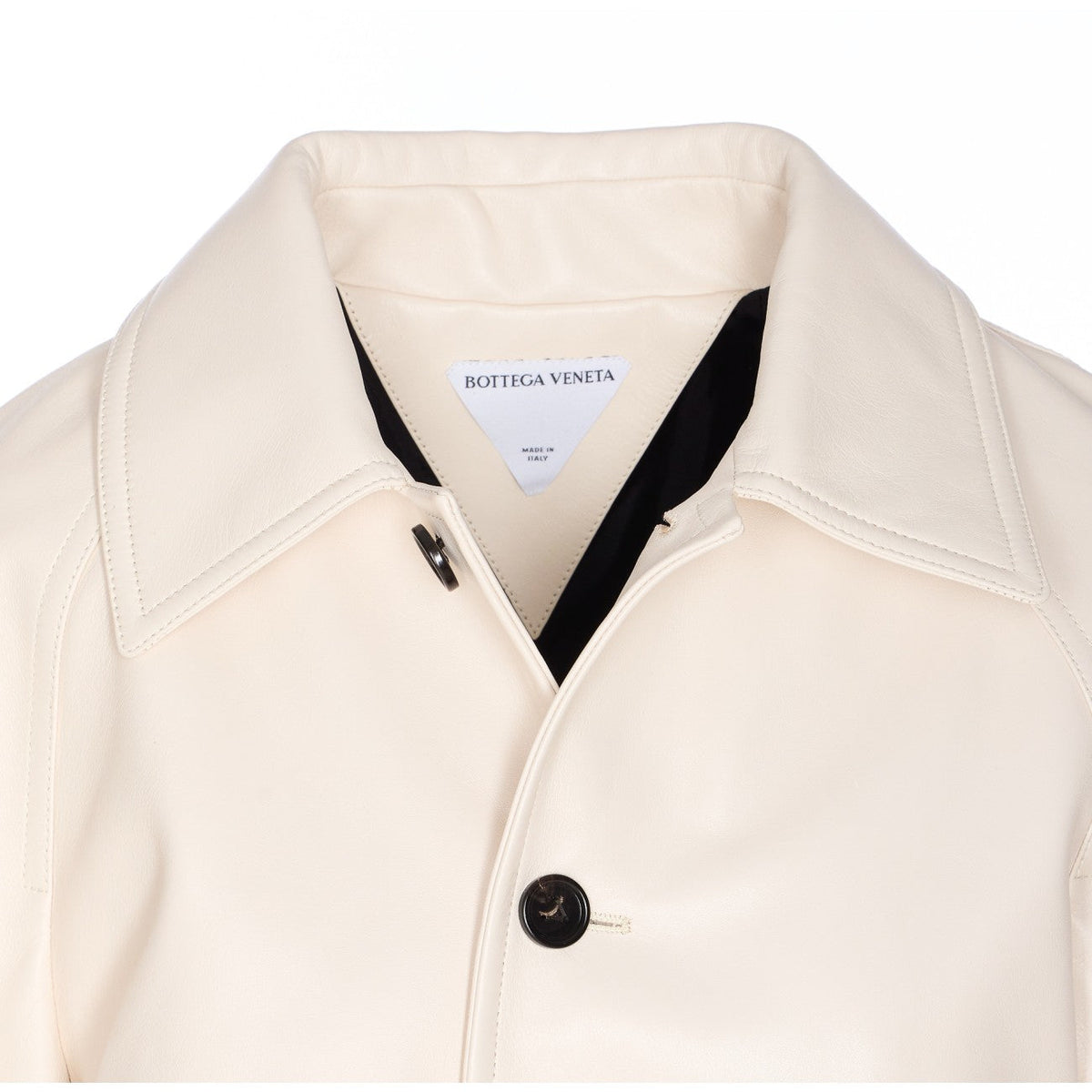 Close-up of Bottega Veneta coats hardware and fine stitching